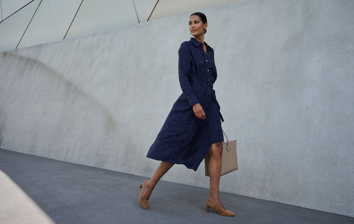 Editorial banner featuring Women's Total Motion Merida Classic Dress Pumps